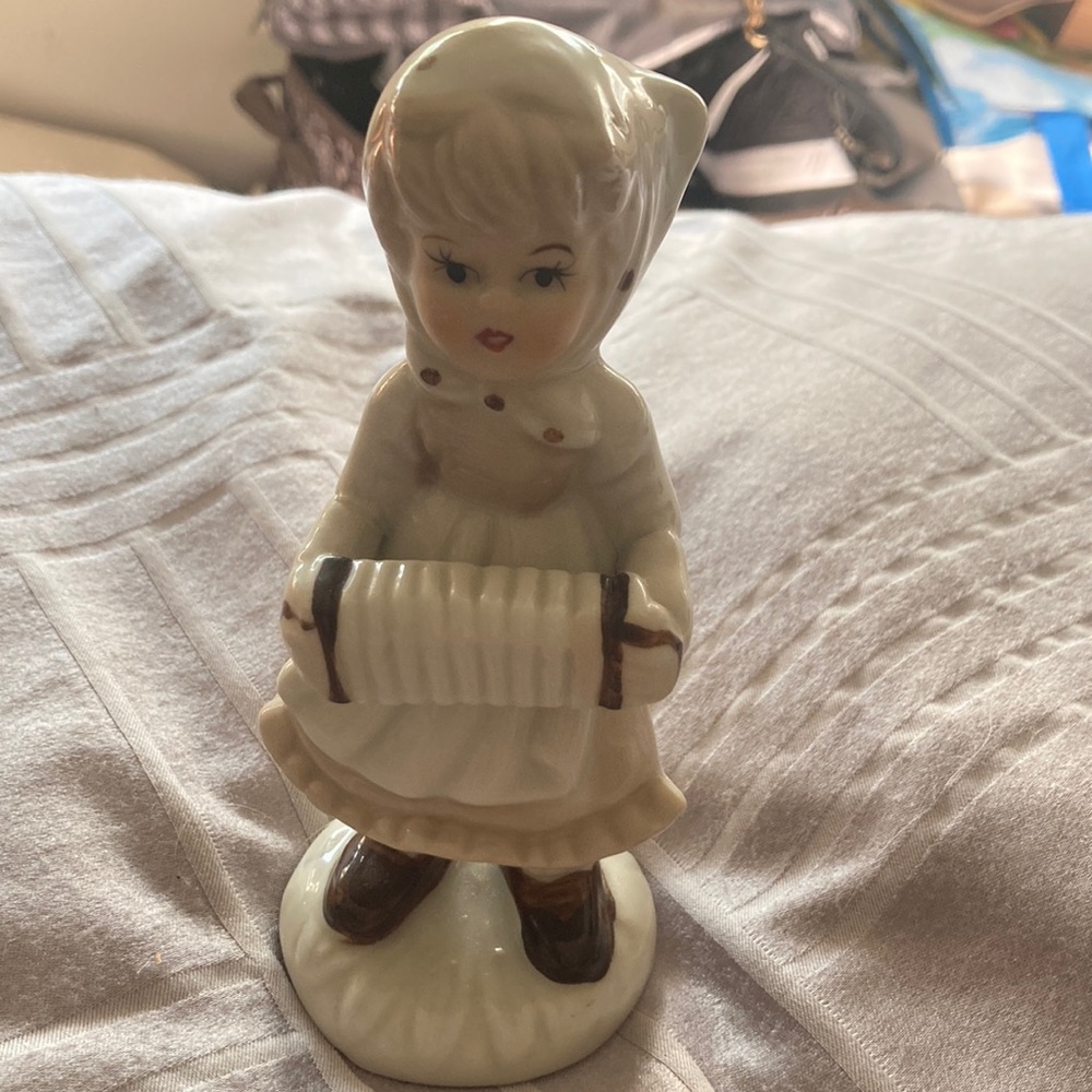 Vintage porcelain girl with scarf and a accordion
